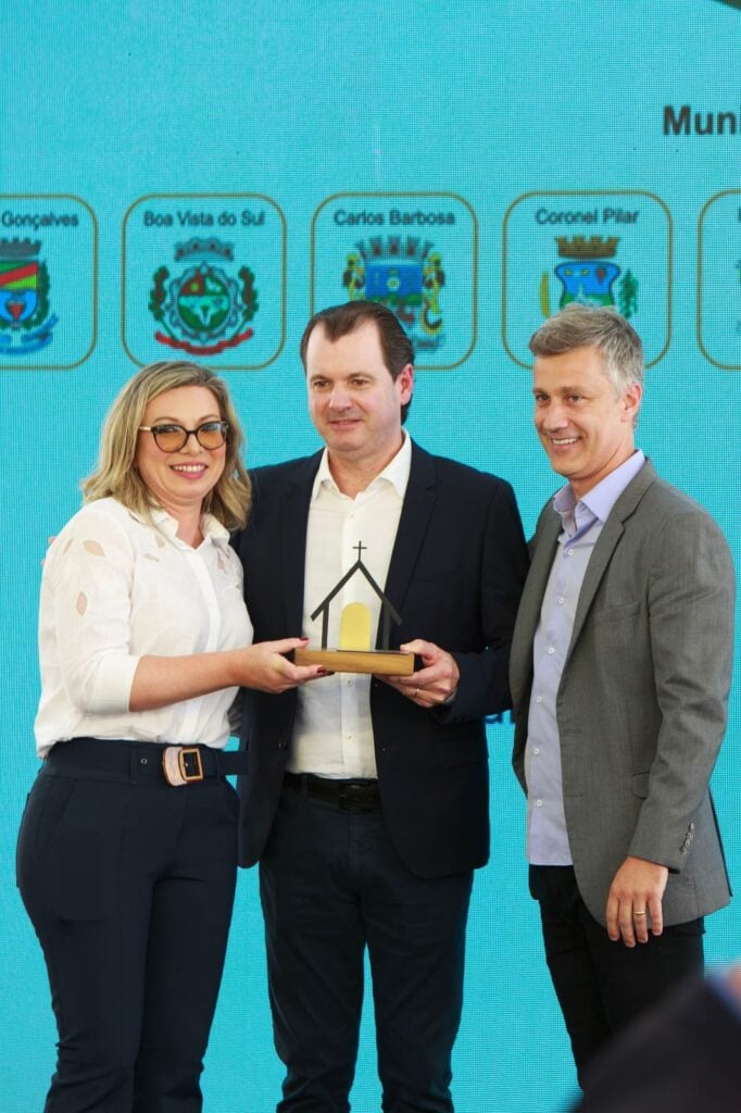 Marijane Paese e Rogério Capoani entregam homenagem a Adriano Miolo (centro), idealizador da Rota dos Capitéis.